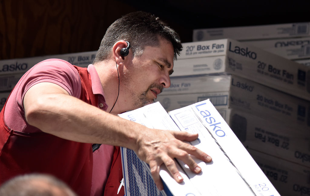 Dave Schad, helps to load the final fans onto the Salvation Army van